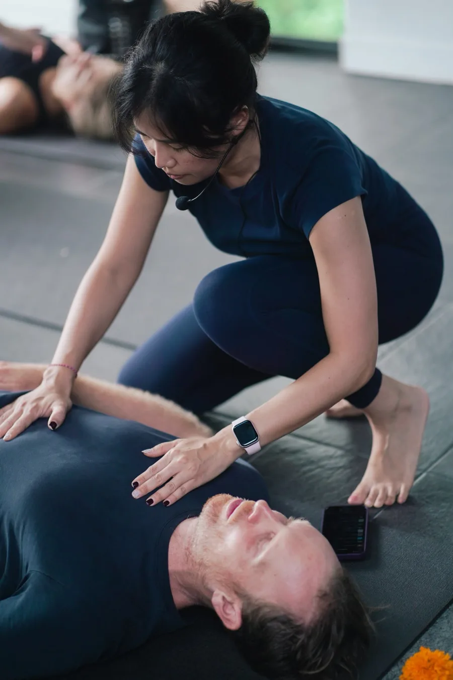 Client resting during a guided breathwork session at INARA Sanctuary